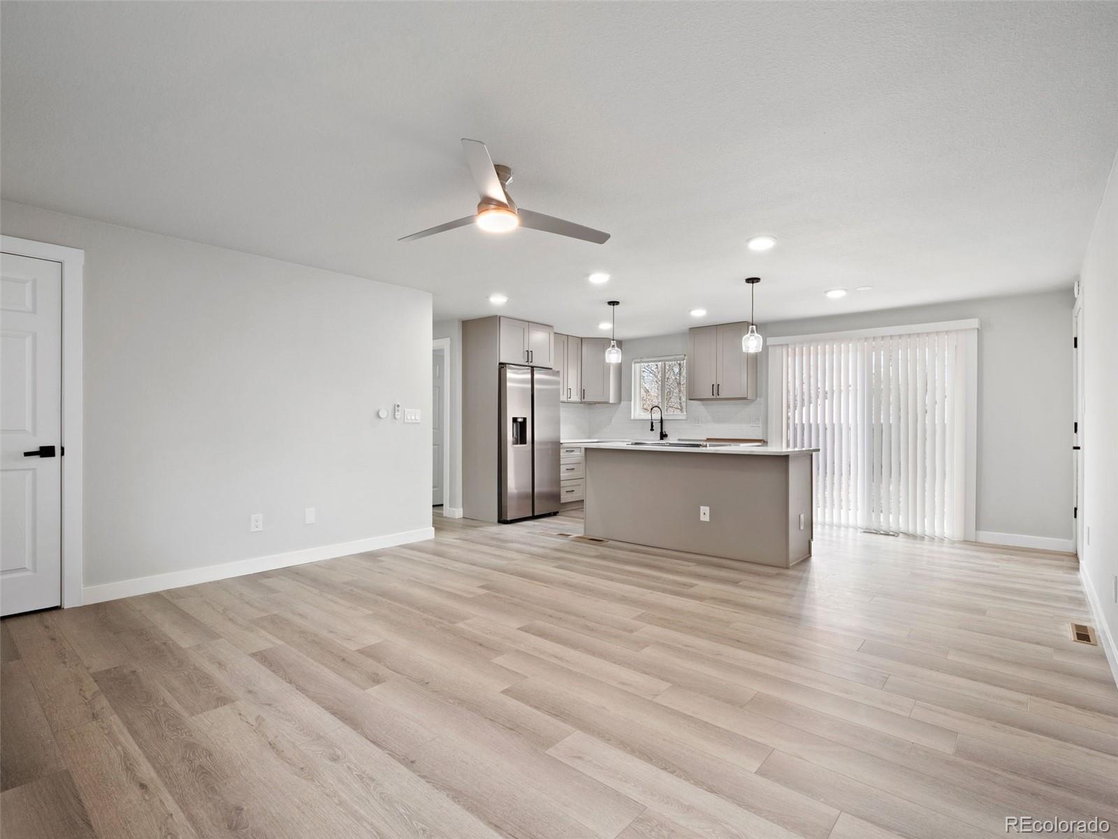 1035 6th Street Berthoud, CO 80513 - Photo 9 of 30 a view of kitchen with kitchen island wooden floor center island and appliances