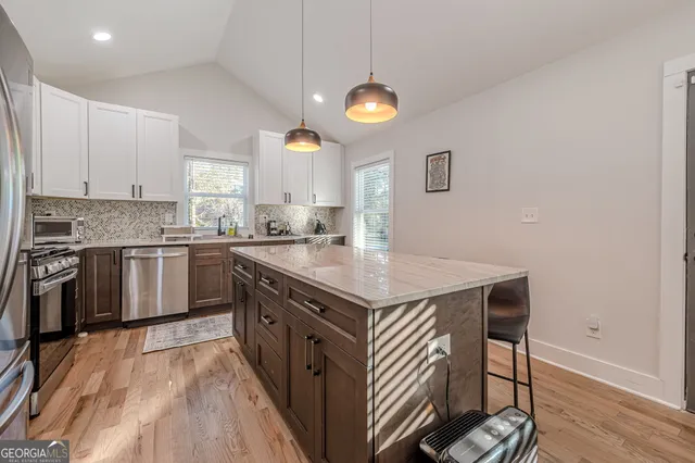 a kitchen with a stove a sink and a refrigerator
