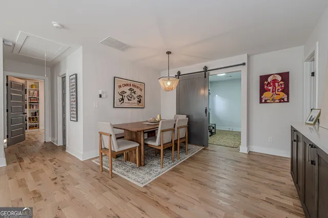 a view of a dining room with furniture and wooden floor