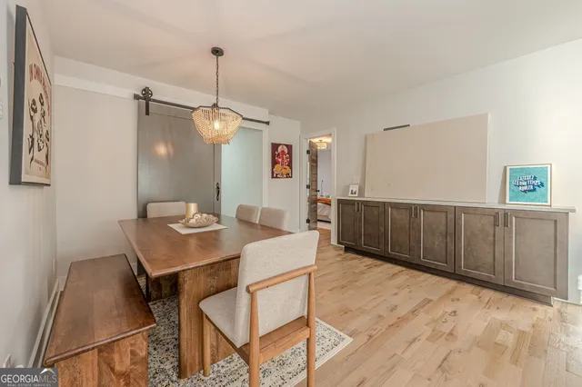 a view of a workspace with furniture and wooden floor