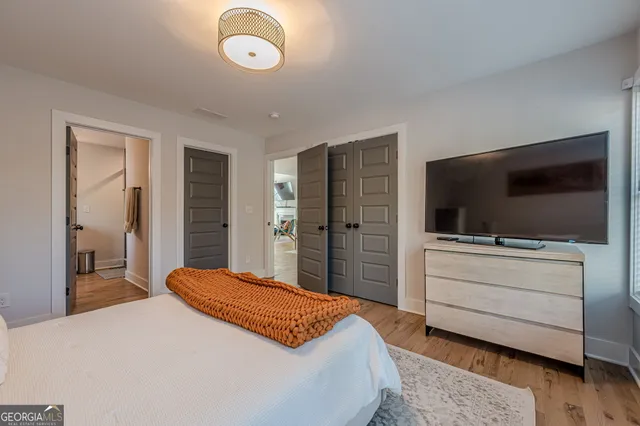 a bedroom with a bed and a flat screen tv