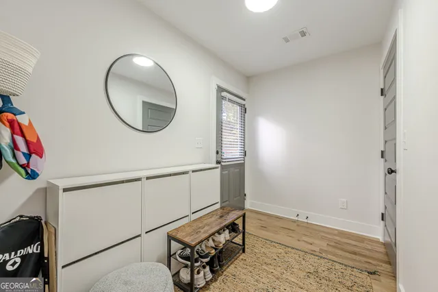 a view of a livingroom with wooden floor and white walls