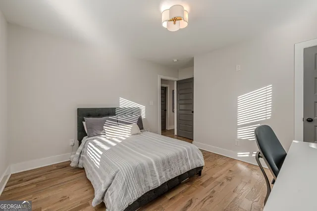 a bedroom with a bed and a chair