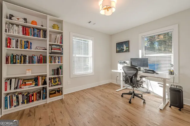 a view of a workspace with furniture and a bookshelf
