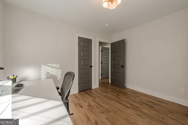 a view of a room with wooden floor and windows