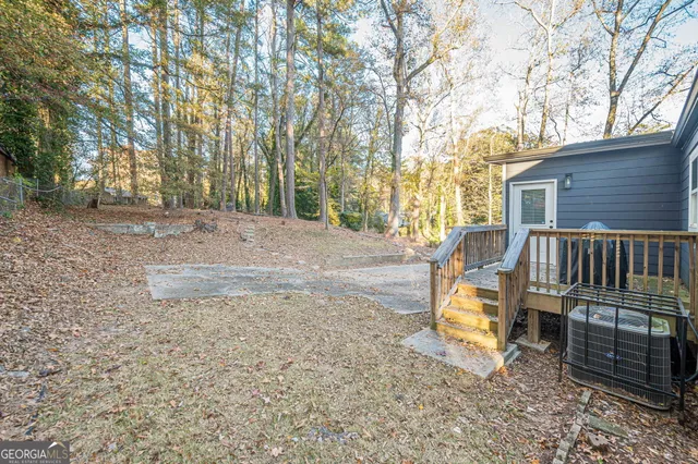 a view of backyard with deck and trees