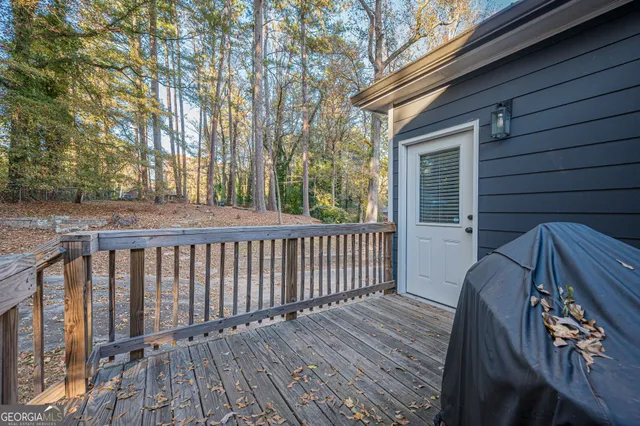 a view of a house with a large tree and a yard