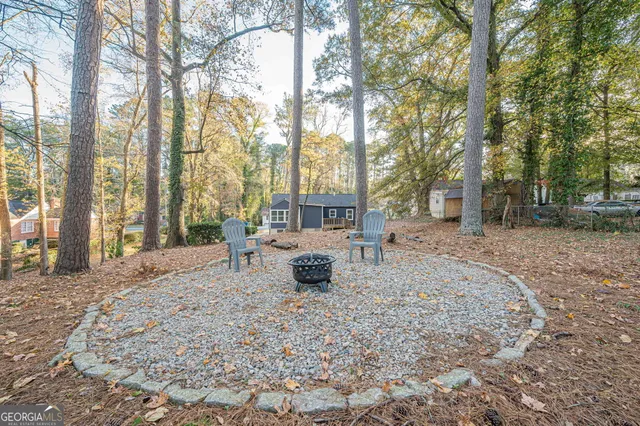 a view of a yard with large trees