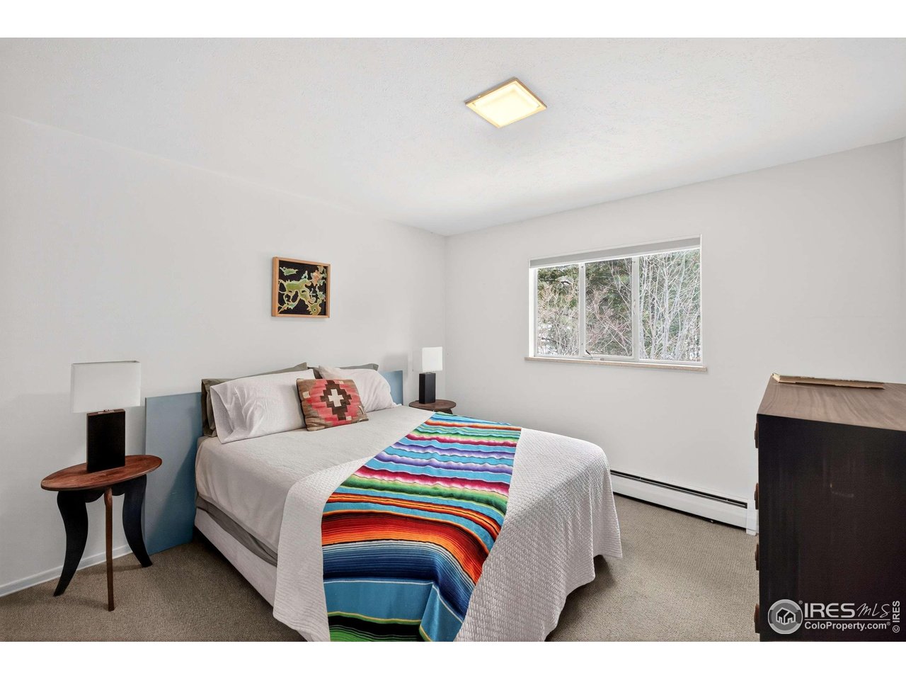 4 Porphyry View Jamestown, CO 80455 - Photo 15 of 34 a bedroom with a bed and a lamp