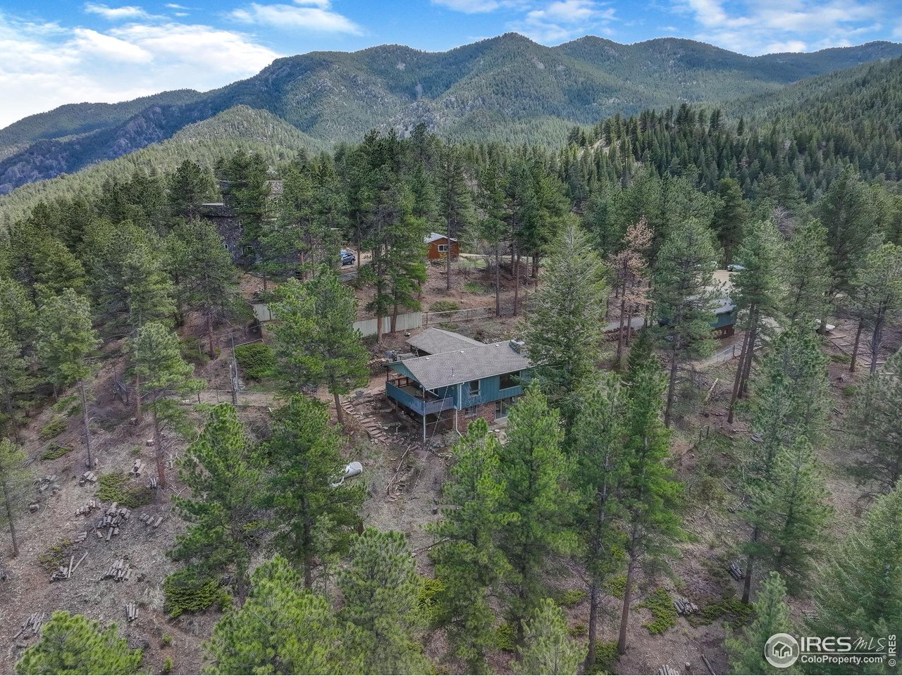 4 Porphyry View Jamestown, CO 80455 - Photo 25 of 34 a view of a lush green hillside and a building in the background