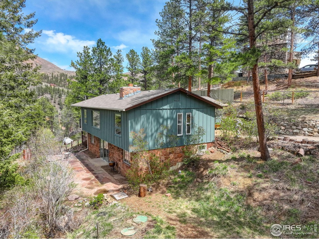 4 Porphyry View Jamestown, CO 80455 - Photo 30 of 34 a view of a house with a yard and large trees