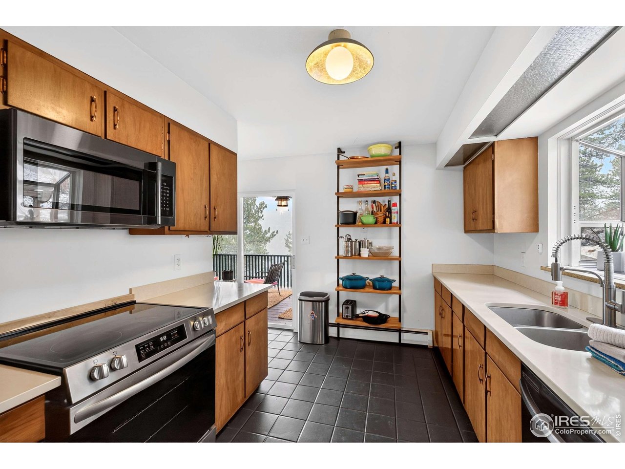 4 Porphyry View Jamestown, CO 80455 - Photo 9 of 34 a kitchen with stainless steel appliances a stove a sink cabinets and a window
