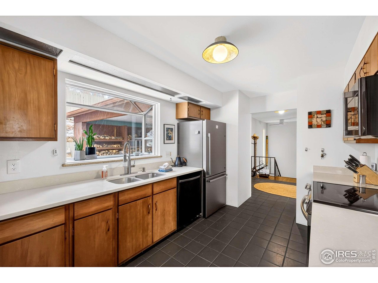 4 Porphyry View Jamestown, CO 80455 - Photo 10 of 34 a kitchen with stainless steel appliances granite countertop a sink cabinets and wooden floor