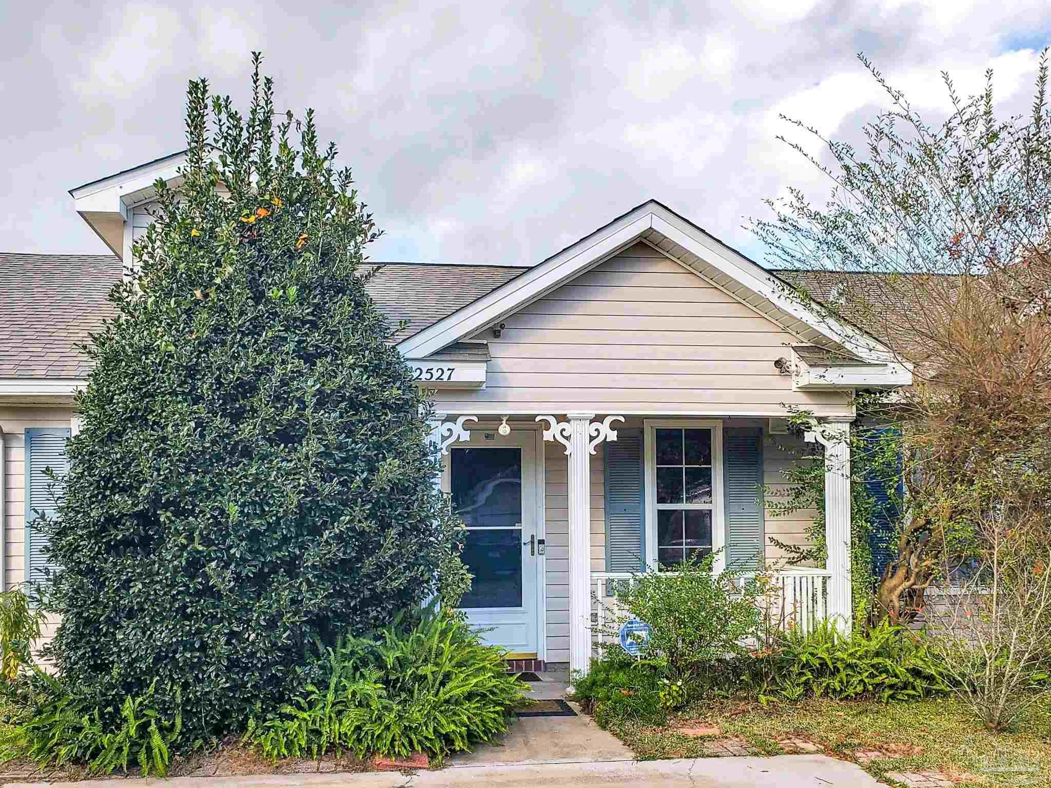 2527 Trailwood Drive Cantonment, FL 32533 - Photo 1 of 12 a front view of a house with a yard and potted plants