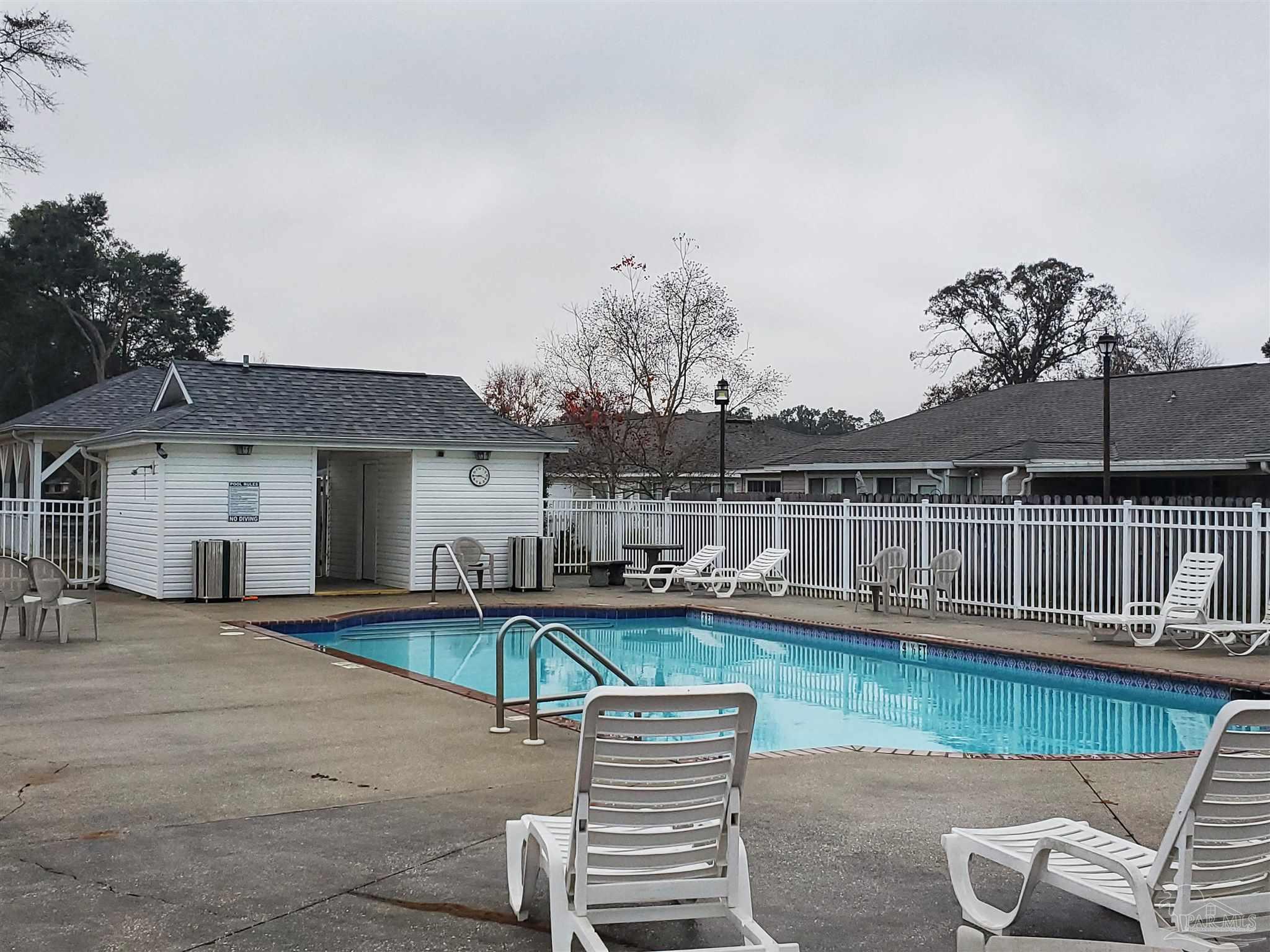 2527 Trailwood Drive Cantonment, FL 32533 - Photo 12 of 12 a view of a patio with table and chairs potted plants and large tree