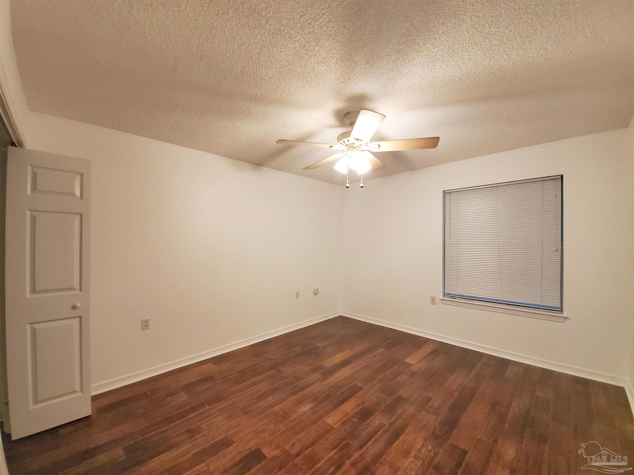 2527 Trailwood Drive Cantonment, FL 32533 - Photo 5 of 12 an empty room with wooden floor and windows