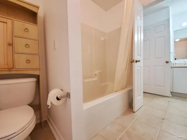 a bathroom with a toilet and a bathtub