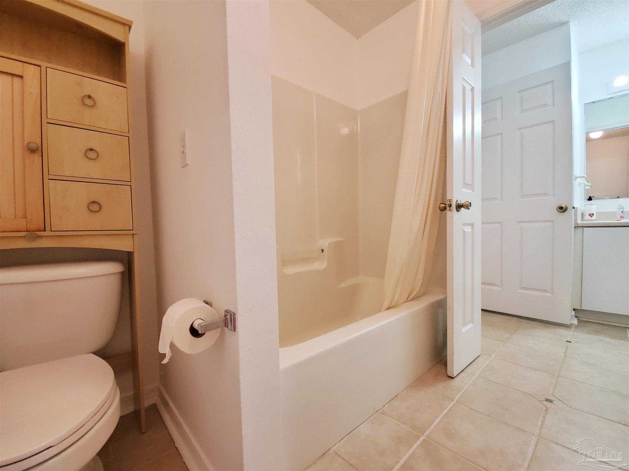2527 Trailwood Drive Cantonment, FL 32533 - Photo 8 of 12 a bathroom with a toilet and a bathtub