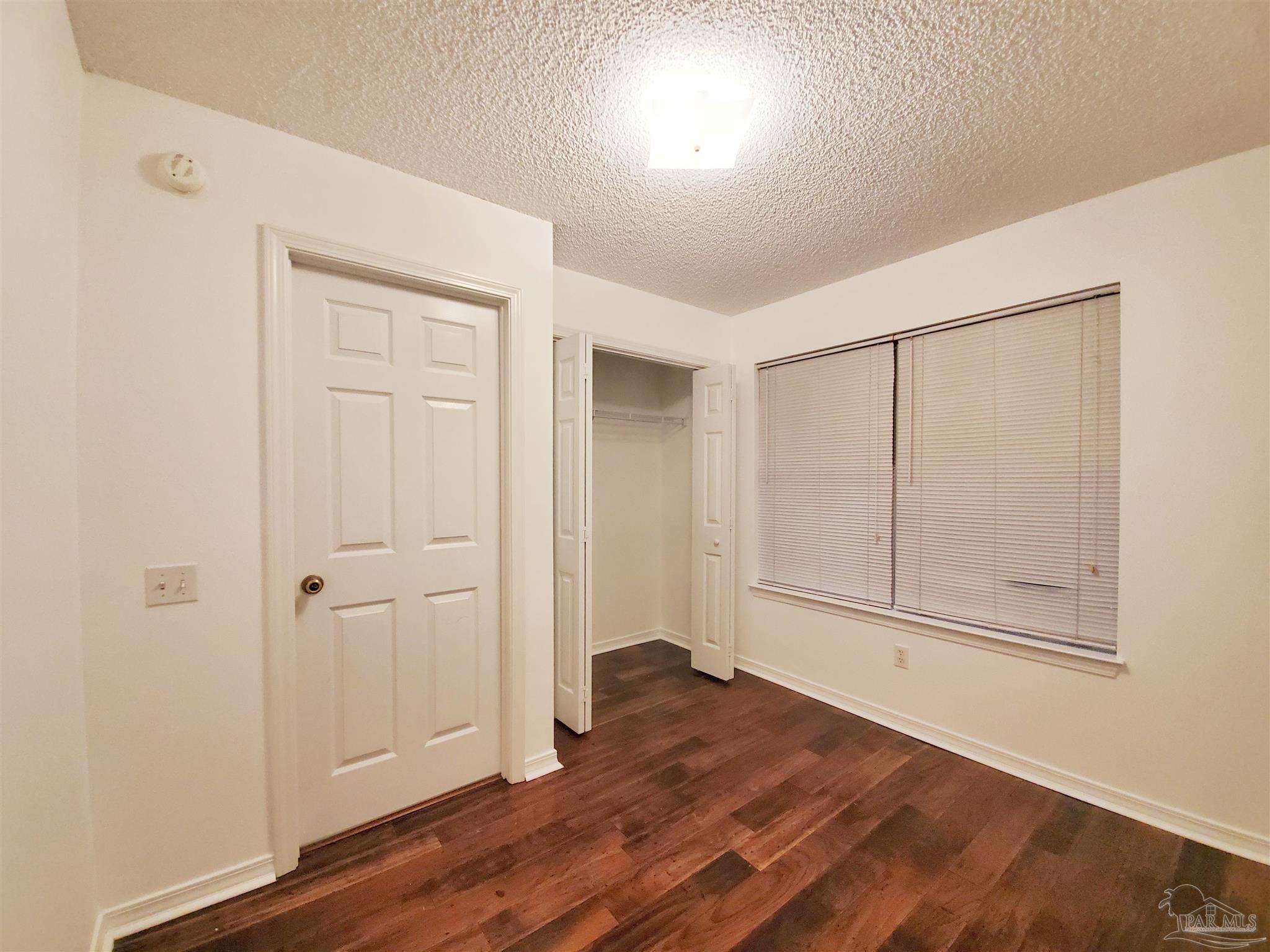 2527 Trailwood Drive Cantonment, FL 32533 - Photo 9 of 12 a view of empty room with wooden floor