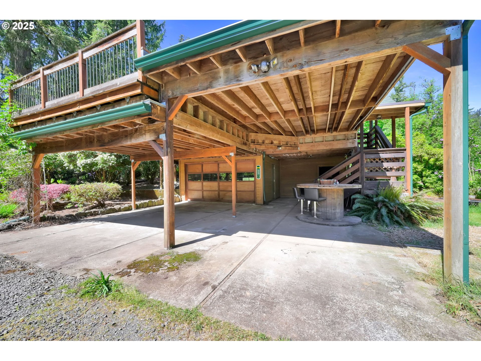 38383 Kickbusch Lane Springfield, OR 97478 - Photo 4 of 44 a view of a patio with table and chairs under an umbrella