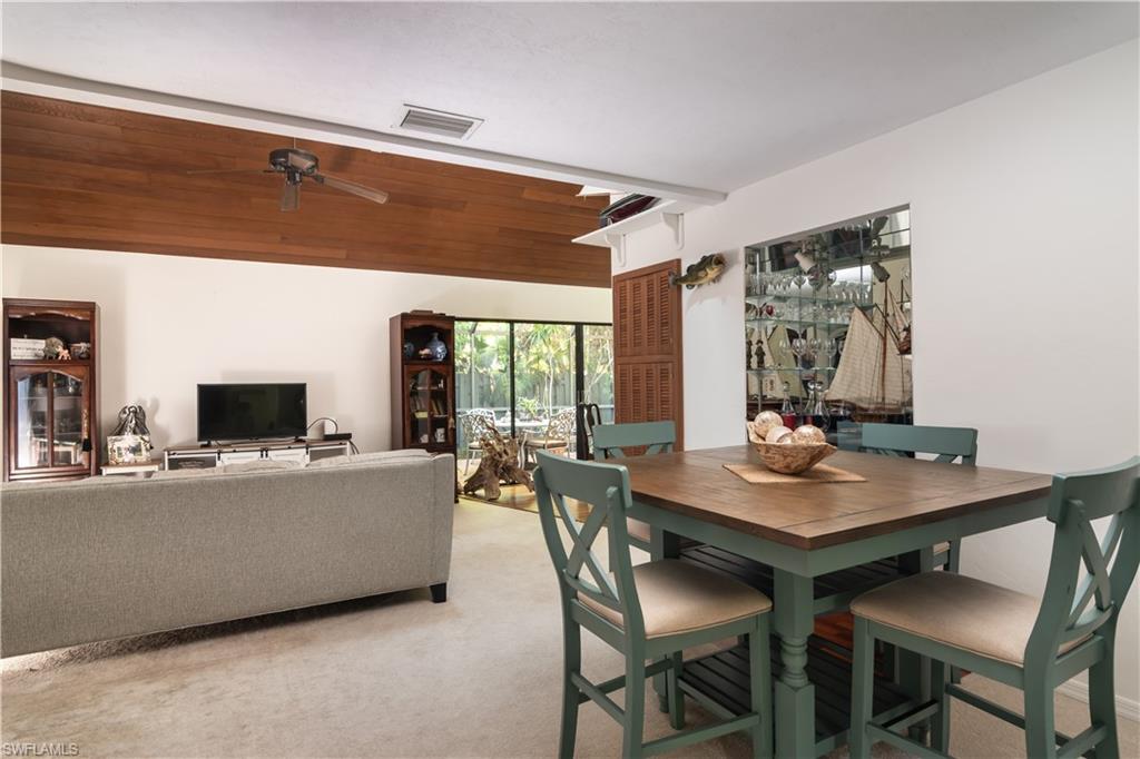 1295 Solana Road, Unit C5 Naples, FL 34103 - Photo 3 of 13 a view of a dining room with furniture and window