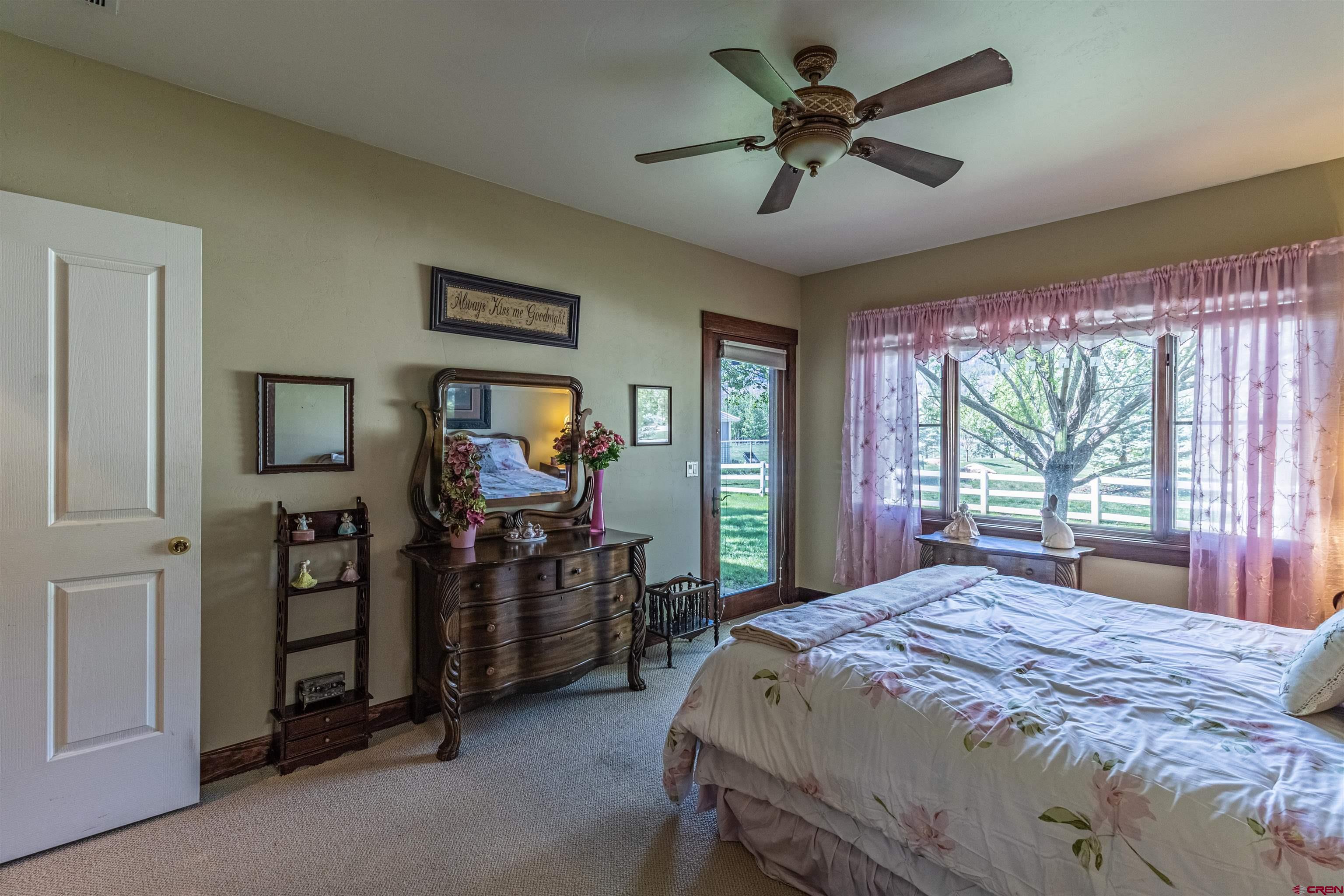 1167 North Dalton Ranch Road Durango, CO 81301 - Photo 23 of 45 a bedroom with a bed and a large mirror with a chandelier