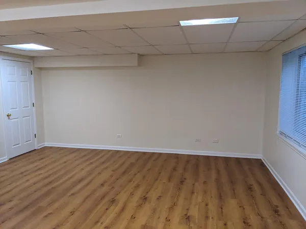 a view of an empty room and wooden floor