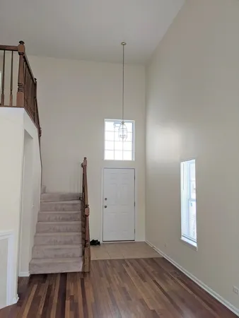 a view of a room with wooden floor and white walls