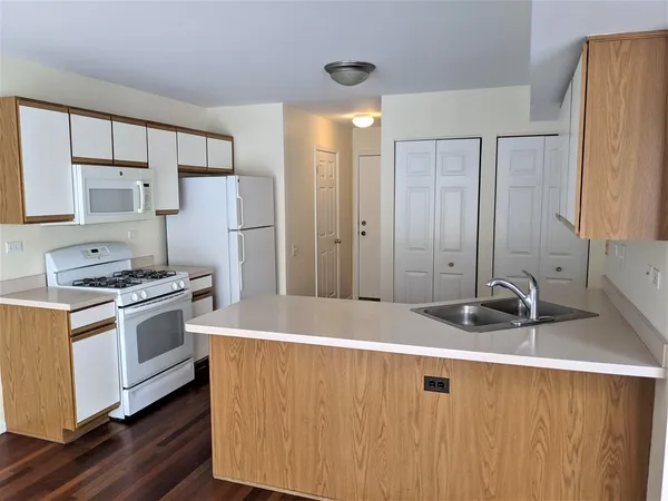 a kitchen with a sink stove and refrigerator