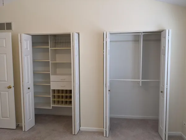 a view of an empty room with closet