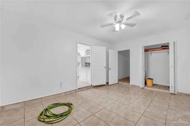 a view of an empty room with a fan