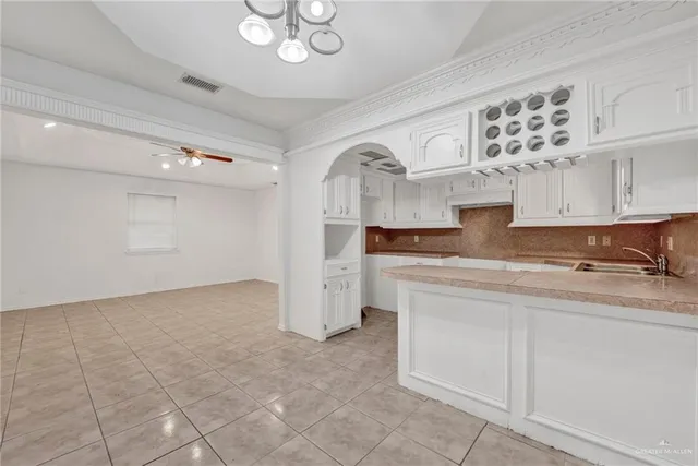 a kitchen with cabinets and window