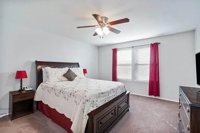 a bedroom with a bed and window