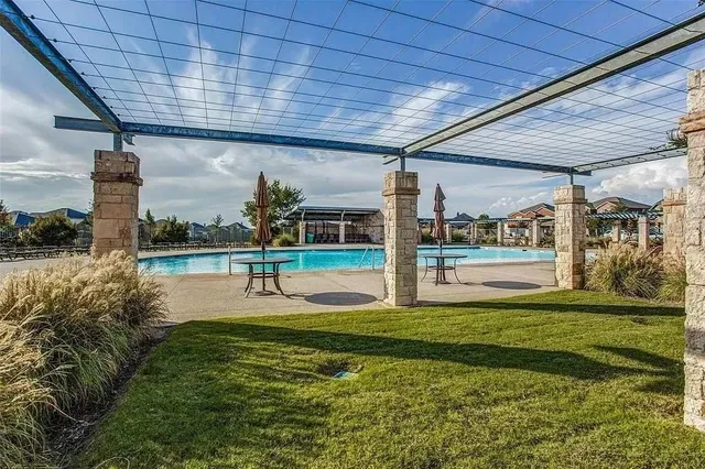 a swimming pool with outdoor seating and yard