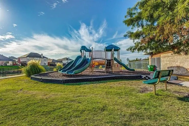 a view of a swimming pool with a bench and lawn chairs