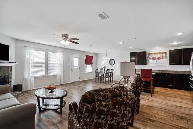 a living room with furniture and wooden floor