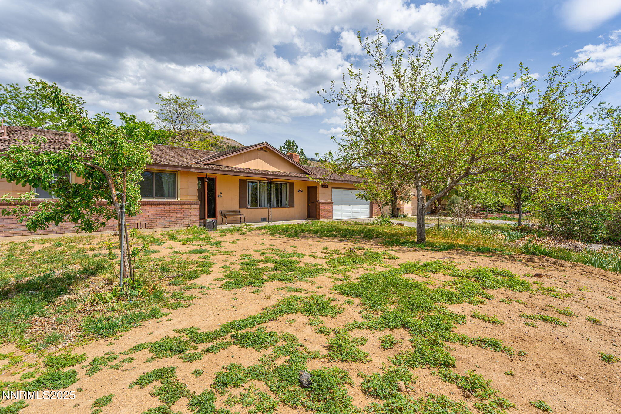 14590 Rancheros Drive Reno, NV 89521 - Photo 1 of 31 a front view of a house with a garden