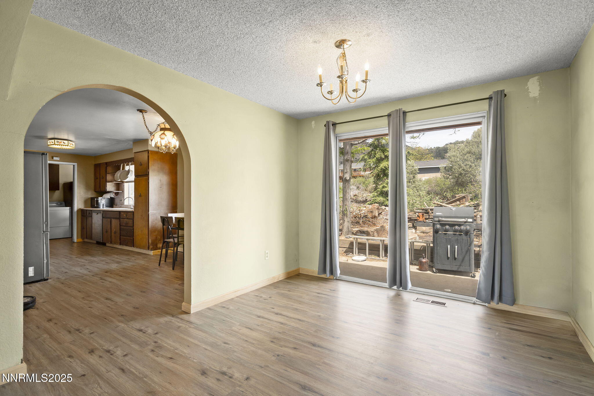 14590 Rancheros Drive Reno, NV 89521 - Photo 11 of 31 a view of a livingroom with wooden floor and a large window