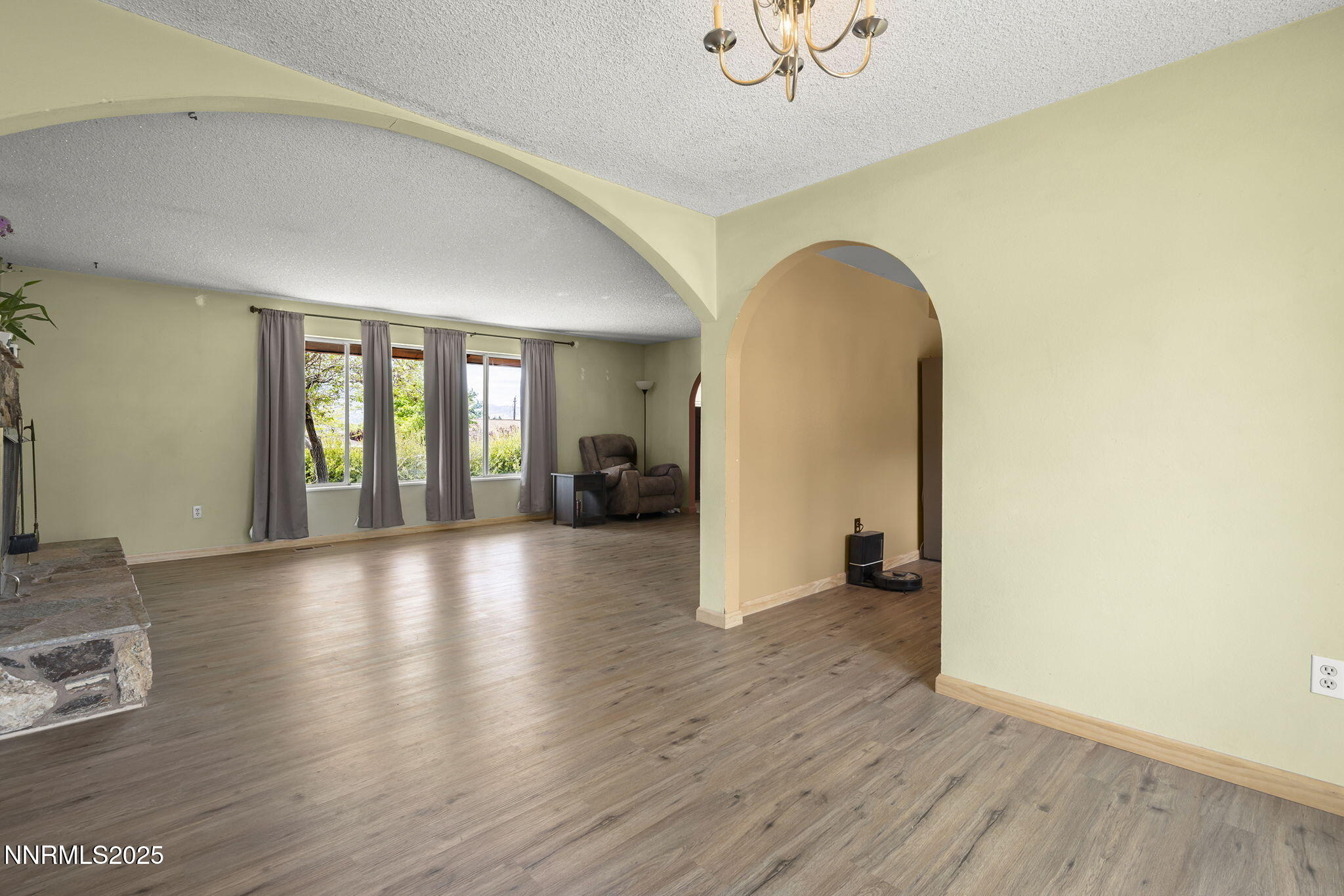 14590 Rancheros Drive Reno, NV 89521 - Photo 12 of 31 a view of an empty room with wooden floor and a window