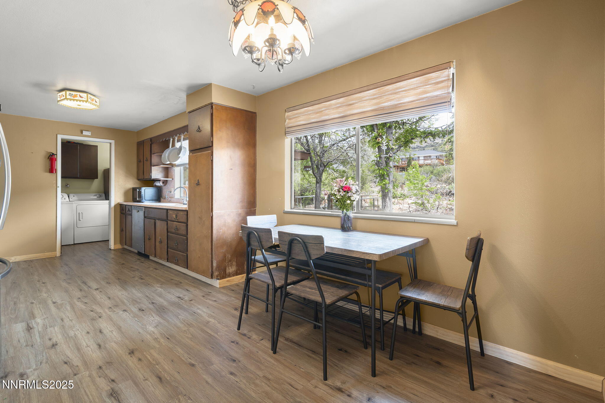 14590 Rancheros Drive Reno, NV 89521 - Photo 13 of 31 a dining room with furniture a window and wooden floor