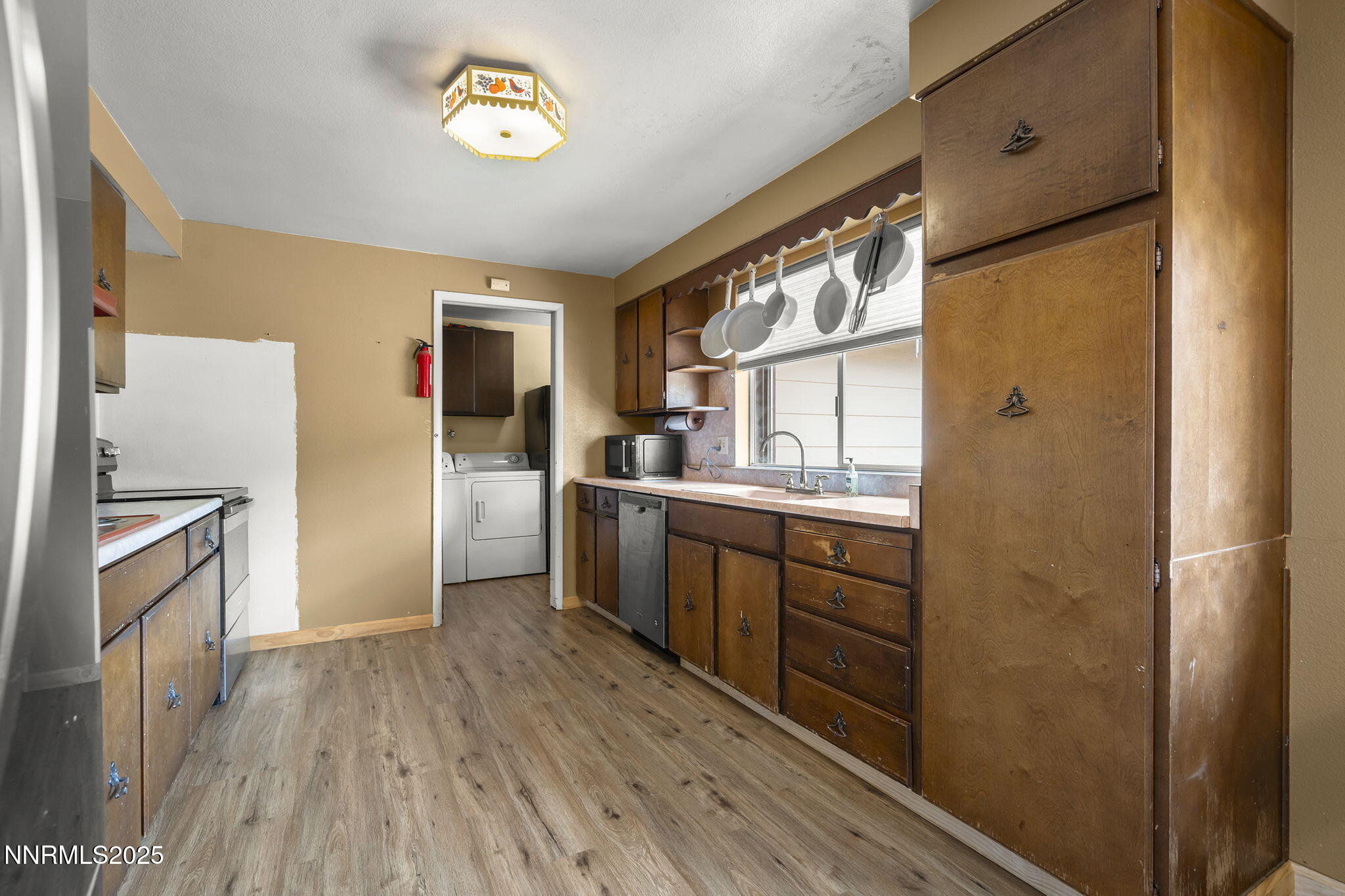 14590 Rancheros Drive Reno, NV 89521 - Photo 14 of 31 a kitchen with a refrigerator a sink and dishwasher with wooden floor