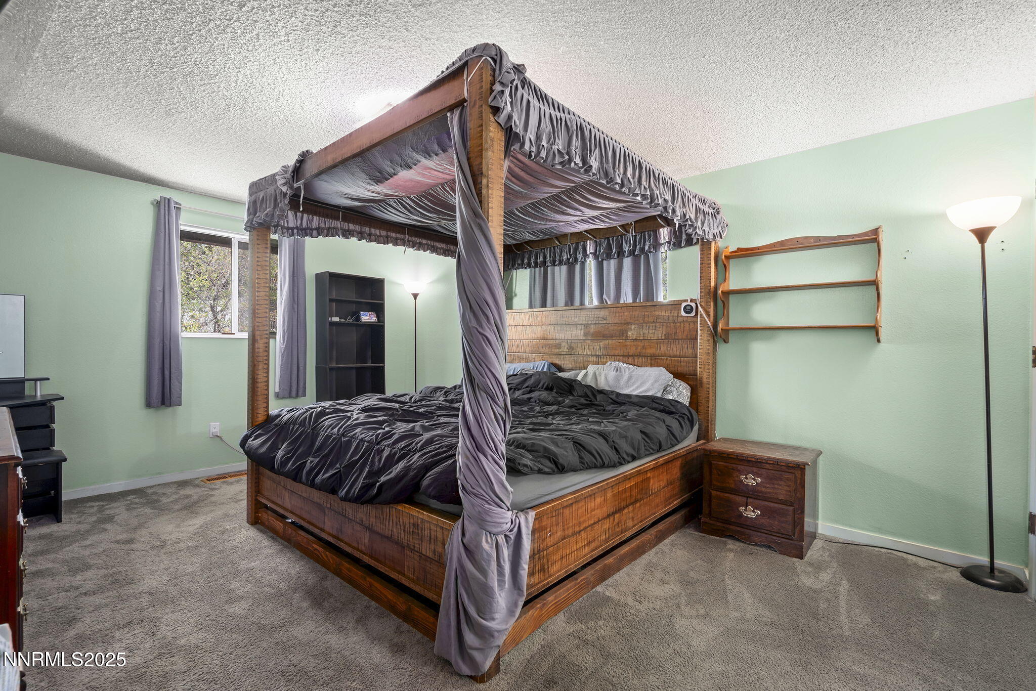 14590 Rancheros Drive Reno, NV 89521 - Photo 16 of 31 a bed sitting in a room next to a window