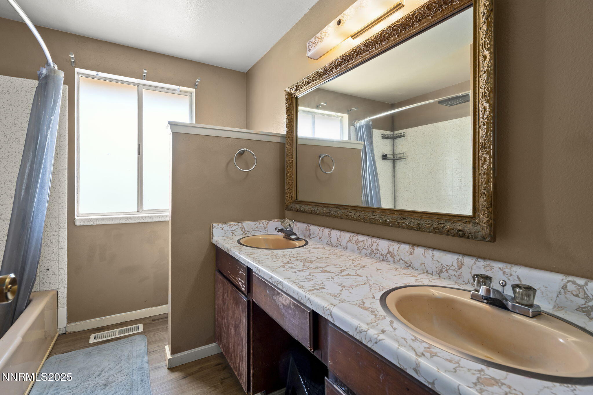 14590 Rancheros Drive Reno, NV 89521 - Photo 20 of 31 a bathroom with a granite countertop sink and a mirror