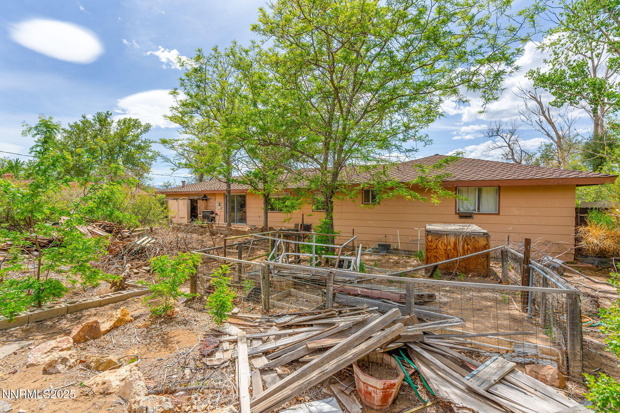 14590 Rancheros Drive Reno, NV 89521 - Photo 25 of 31 a view of a patio with table and chairs under an umbrella