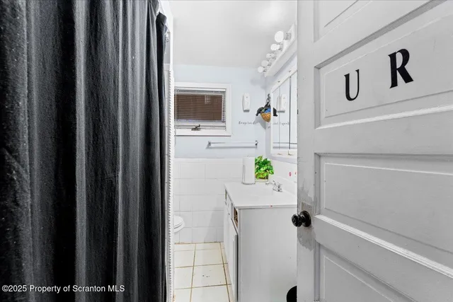 a bathroom with a shower and mirror