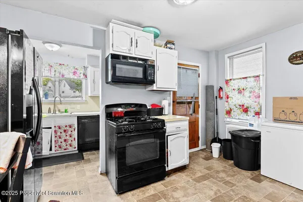 a kitchen with stainless steel appliances a stove a microwave and cabinets