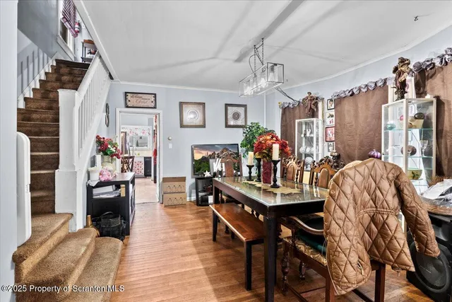 a view of a dining room with furniture and chandelier