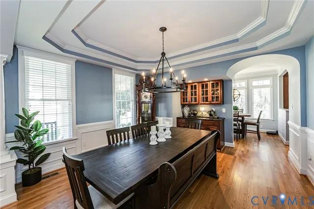 a view of a dining room with furniture window and wooden floor