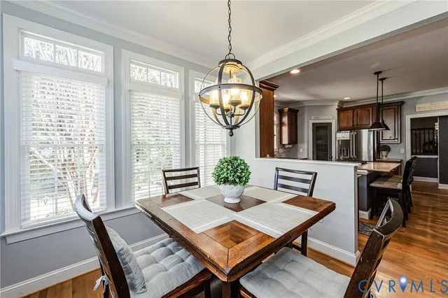 a living room with furniture a window and a chandelier