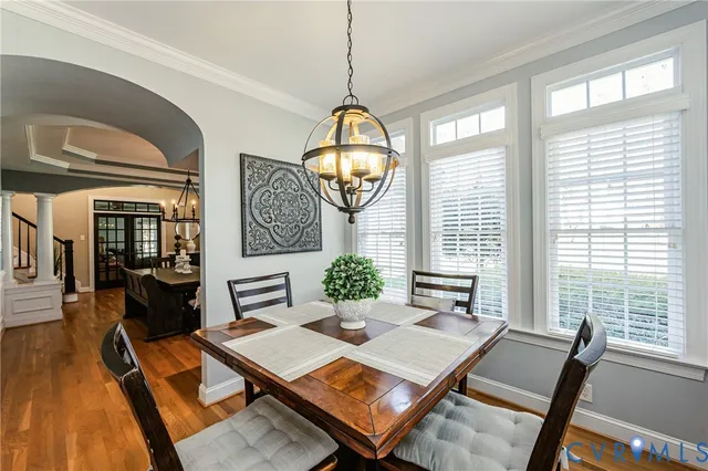 a living room with furniture a table and a large window